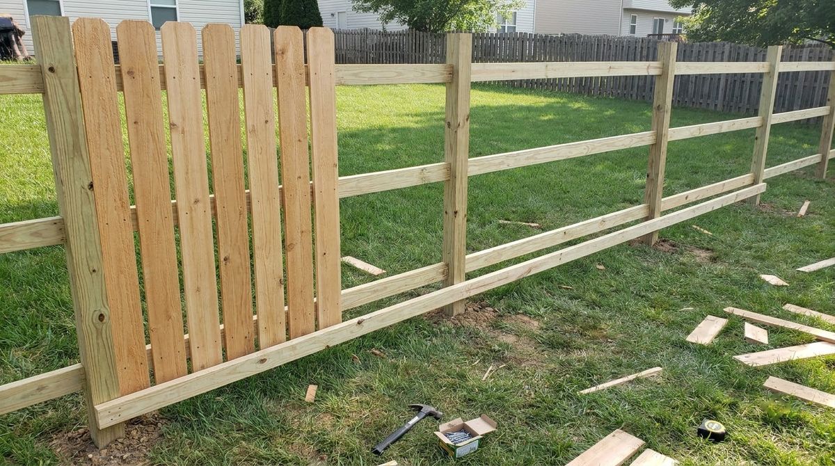 Three horizontal 2x4 rails between wood posts with the first privacy pickets nailed on
