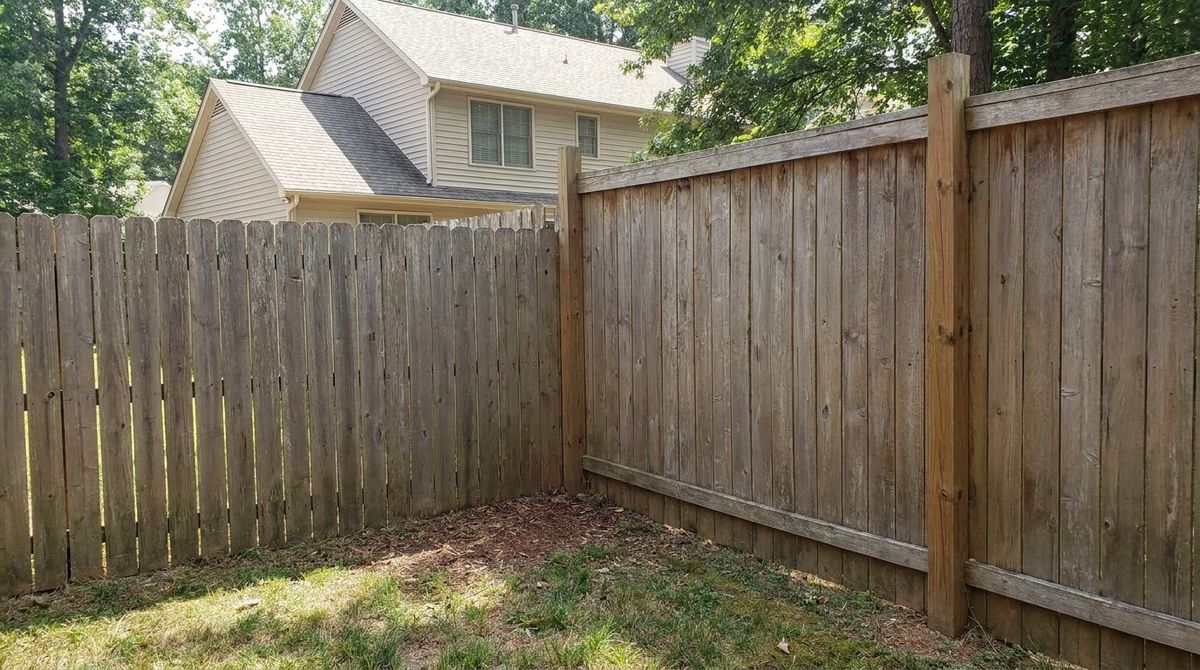 Six-foot and eight-foot wood privacy fence sections side by side on a property line