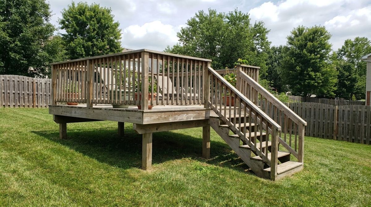 Raised wood deck with simple pressure-treated wood railing and square balusters