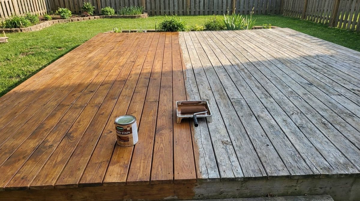 Older wood deck half refinished with fresh brown stain beside weathered gray boards