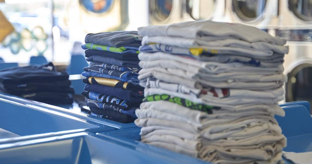 Stack of neatly folded clean shirts on a surface ready for laundry delivery in Saigon