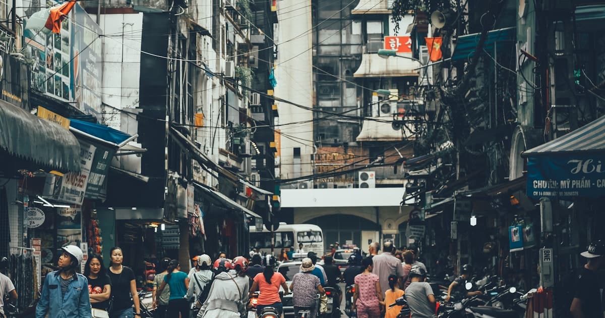 Narrow Hanoi Old Quarter alley between shophouses where backpackers find laundry shops