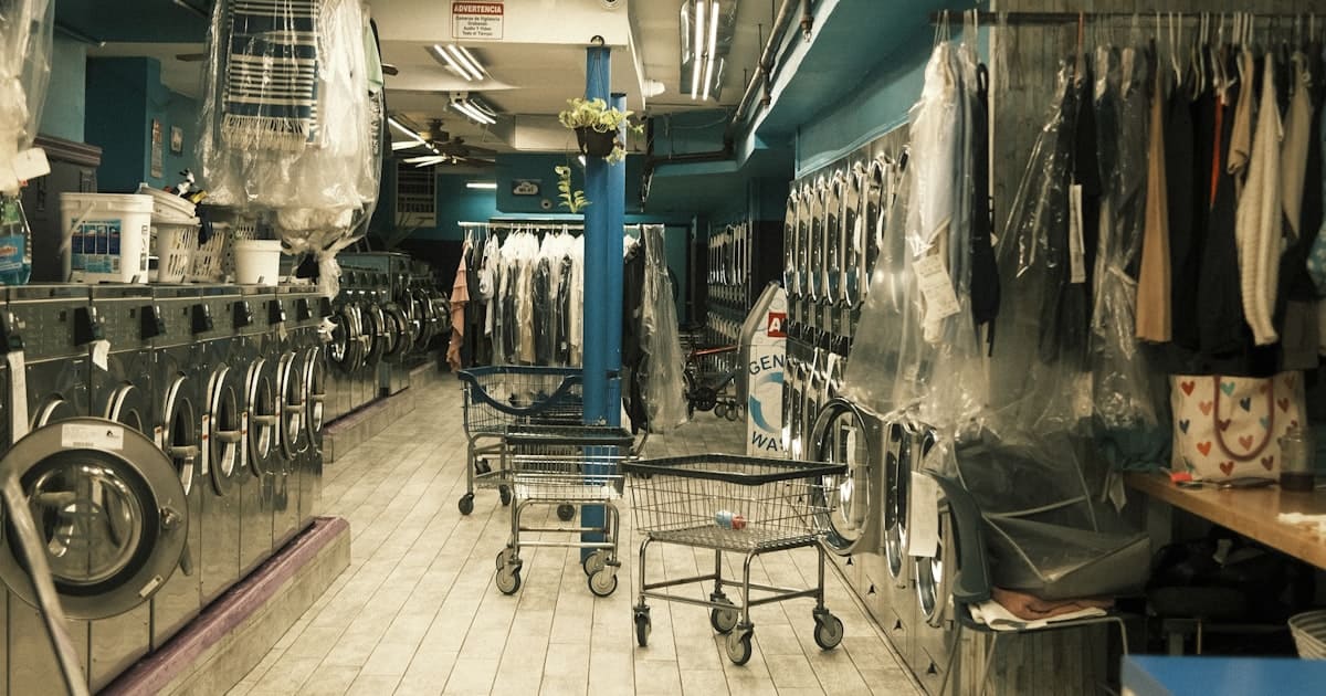 Modern self-service laundromat with rows of front-loading washing machines in Hanoi