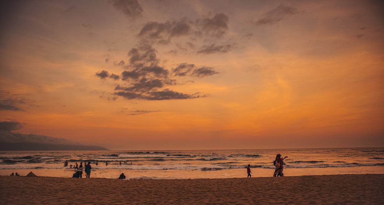 Sunset over My Khe Beach — Da Nang laundry shops cluster in this beach district