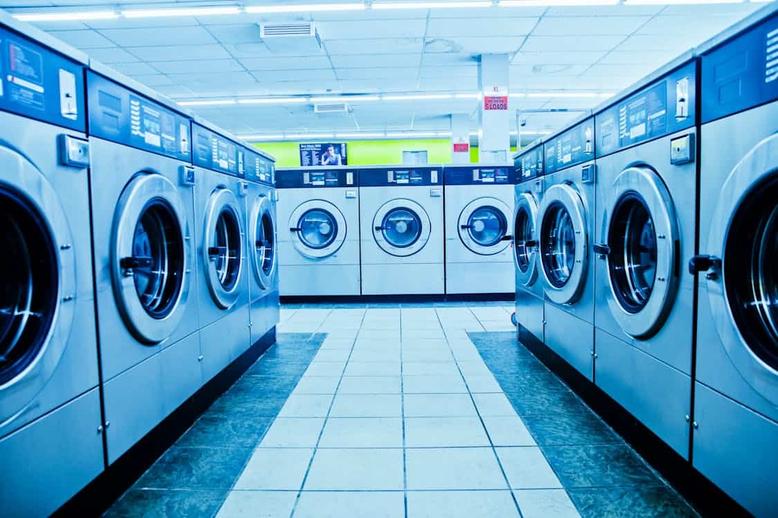 Da Nang laundry shop interior with industrial front-load washing machines