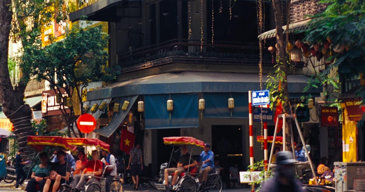 Hanoi Old Quarter street with motorbikes and shophouses where laundry shops cluster