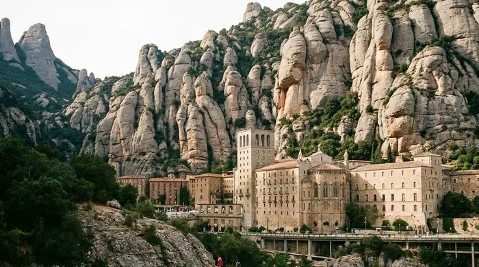 Illustration of a monastery below serrated rock peaks at Montserrat