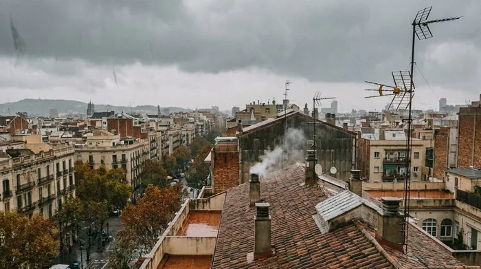 Illustration of grey autumn clouds over Barcelona's rooftops