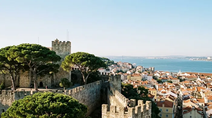 Illustration of castle walls on a hilltop above Lisbon