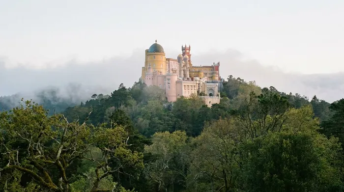 Illustration of a colourful palace above the forest near Sintra