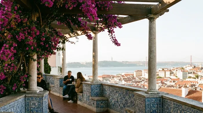 Illustration of a tiled viewpoint terrace over Lisbon rooftops