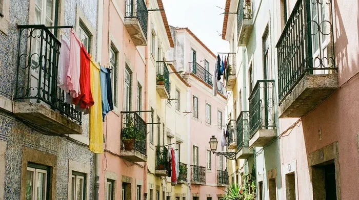 Illustration of laundry hanging from tiled balconies in Lisbon