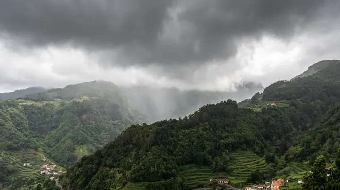 Illustration of rain clouds rolling over Madeira's green mountains
