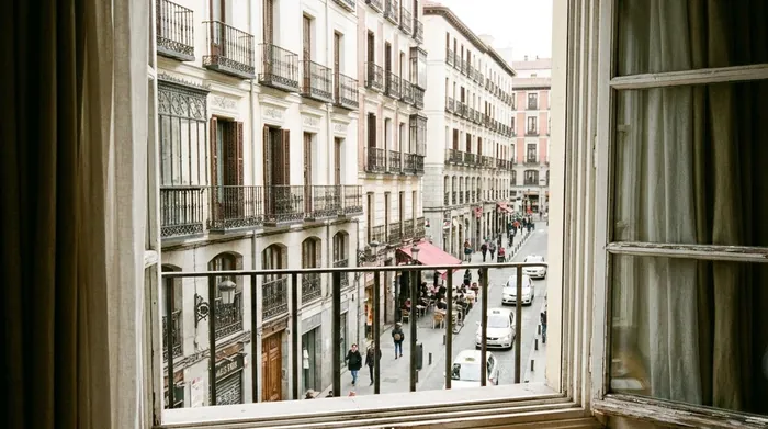 Illustration of a view from a hotel window onto a Madrid street