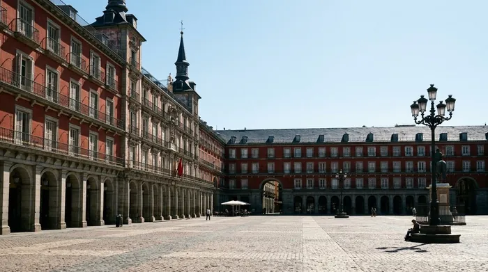 Illustration of an arcaded square in Madrid in bright midday sun
