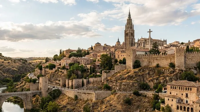 Illustration of the walled hill city of Toledo above its river