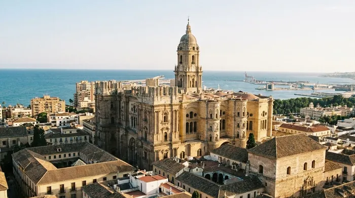 Illustration of Málaga's old town rooftops, cathedral and sea