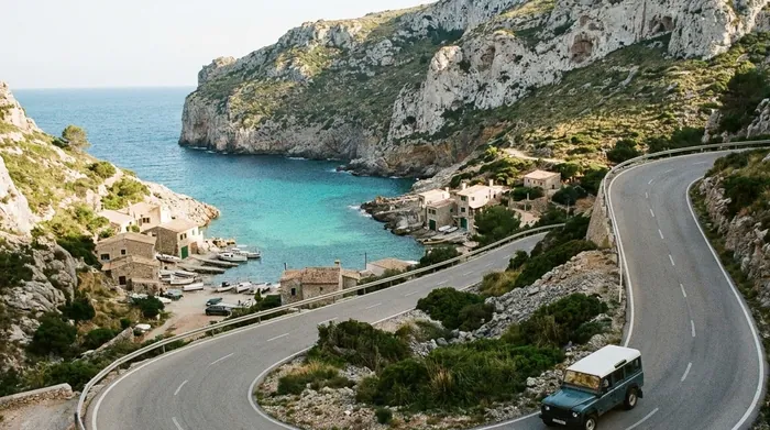 Illustration of a hairpin road descending to a cove on Mallorca