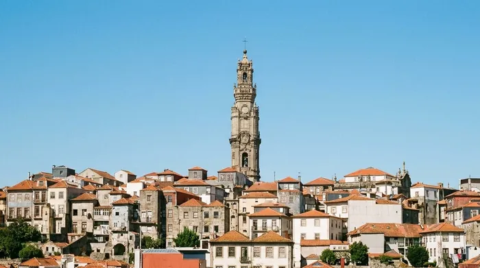 Illustration of a baroque church tower above Porto's rooftops
