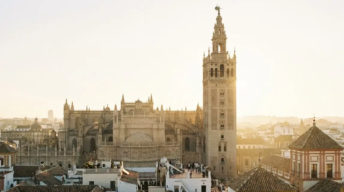 Illustration of Seville's cathedral and bell tower above the old city