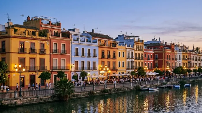 Illustration of colourful riverside houses in Triana at dusk