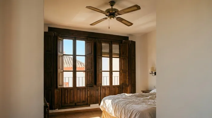 Illustration of a shuttered hotel room on a hot day in Seville