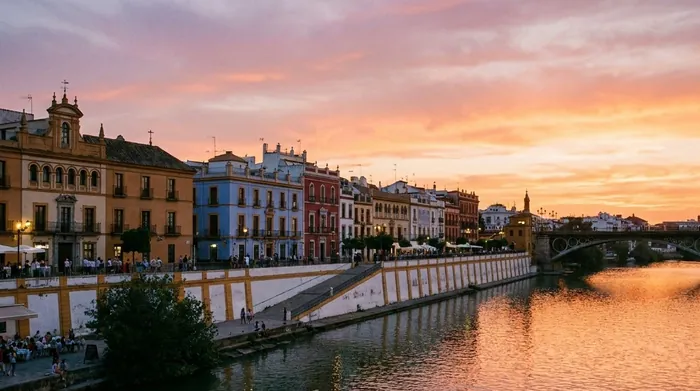 Illustration of colourful riverside houses in Triana at sunset