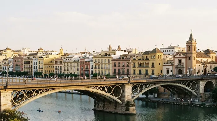 Illustration of an iron bridge over the river to Triana in Seville