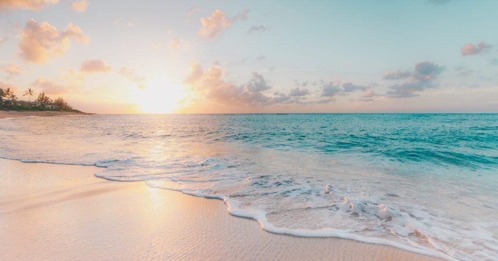 Beautiful tropical beach with golden sand and turquoise waters at sunset. Perfect destination for re.