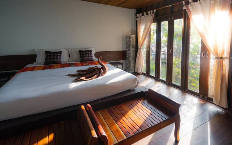 Luxury pool villa with a private infinity pool overlooking a secluded turquoise bay surrounded by tropical vegetation