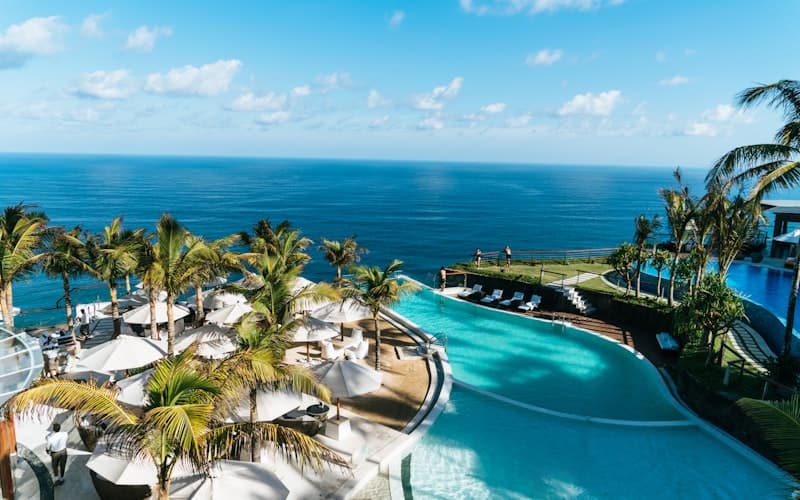 Unique treehouse-style pool villa nestled in tropical rainforest canopy with a curved infinity pool and wooden walkways
