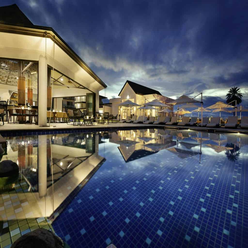 Elegant resort with a pool and sunset view, perfect for relaxing vacations.