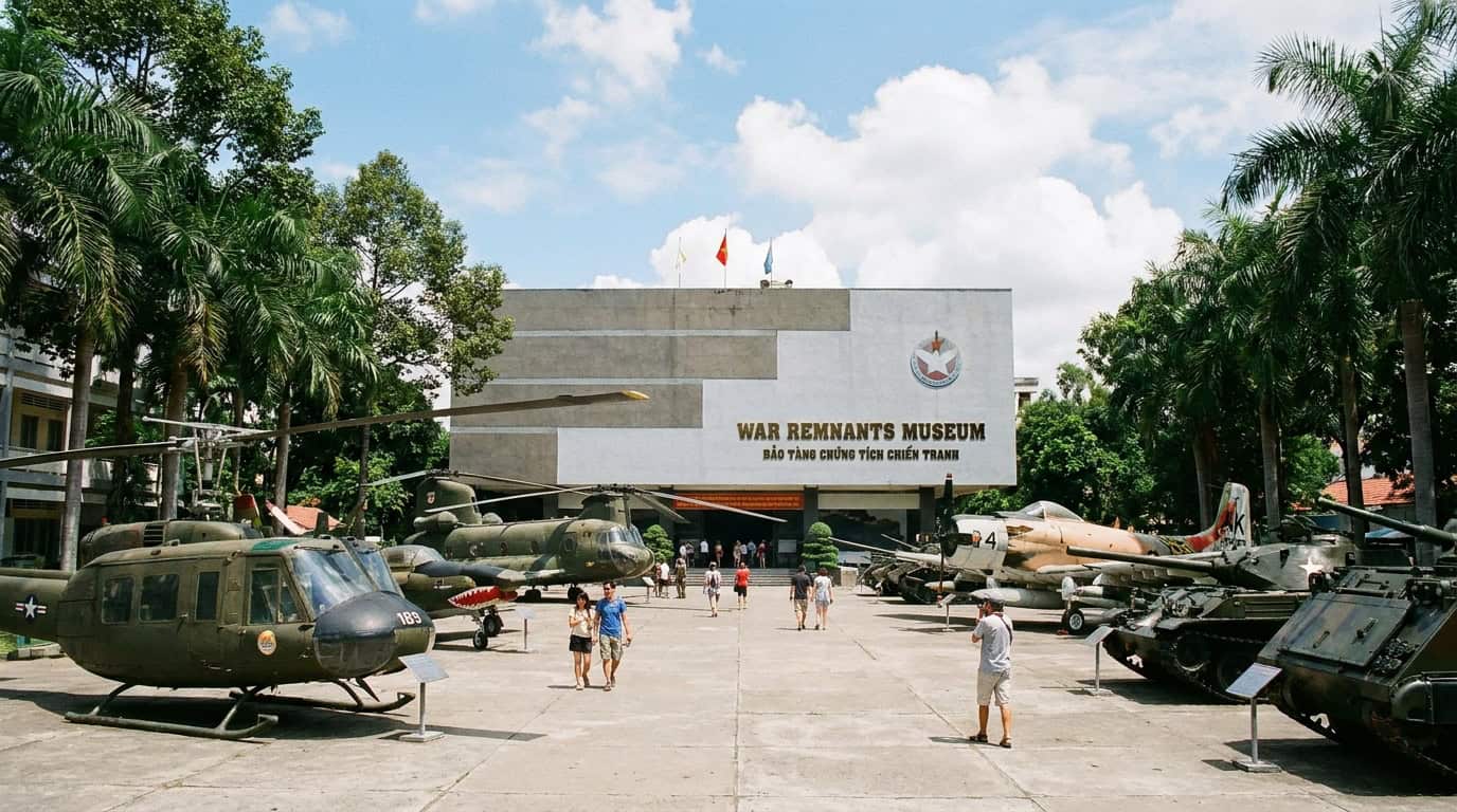Exterior of War Remnants Museum in Ho Chi Minh City with US military aircraft displayed in courtyard