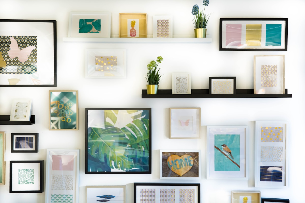 Black-framed grid gallery wall climbing a white-painted staircase