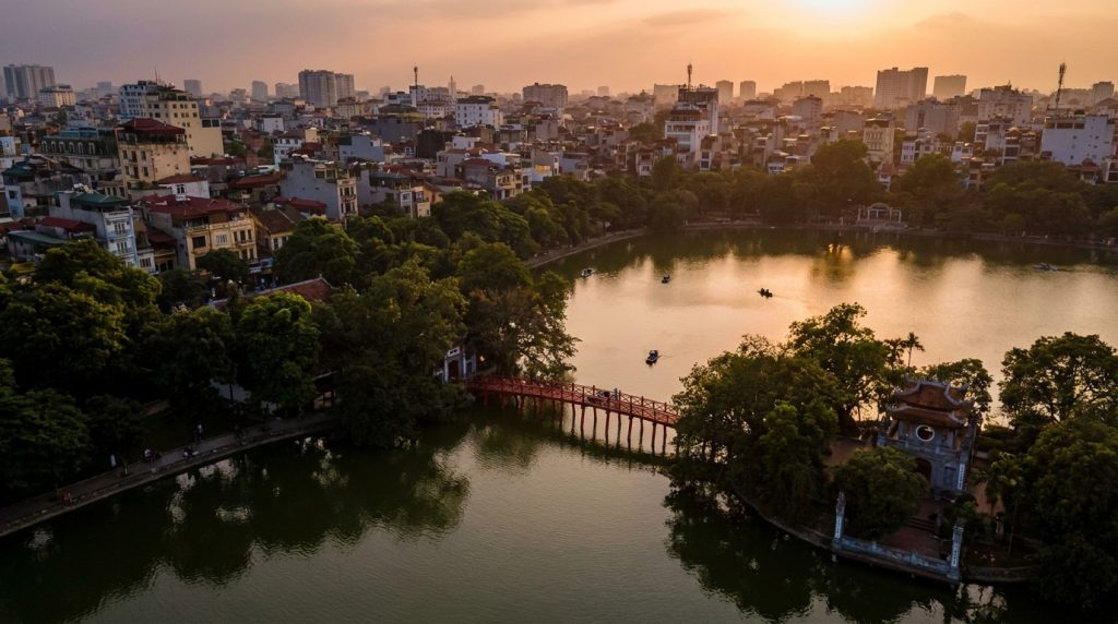 Hanoi Itinerary 3 Days — Hanoi itinerary 3 days featured image showing Hoan Kiem Lake and the red Huc Bridge at sunset
