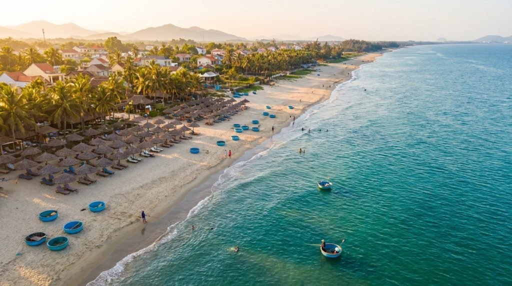 An Bang Beach Hoi an — Golden hour aerial view of An Bang Beach Hoi An with thatched umbrellas and blue fishing coracles