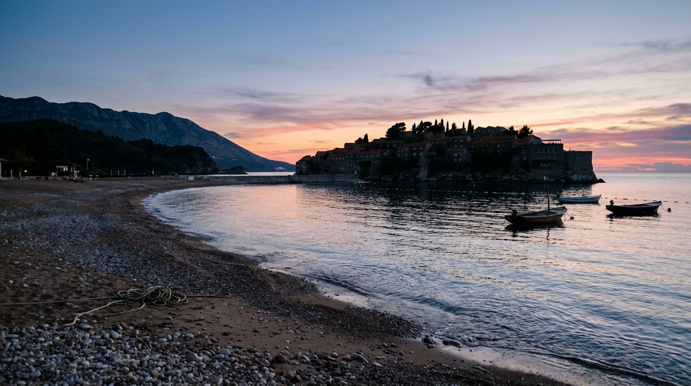 Sveti Stefan public beach at early morning with calm Adriatic water and island silhouette in sveti stefan travel guide