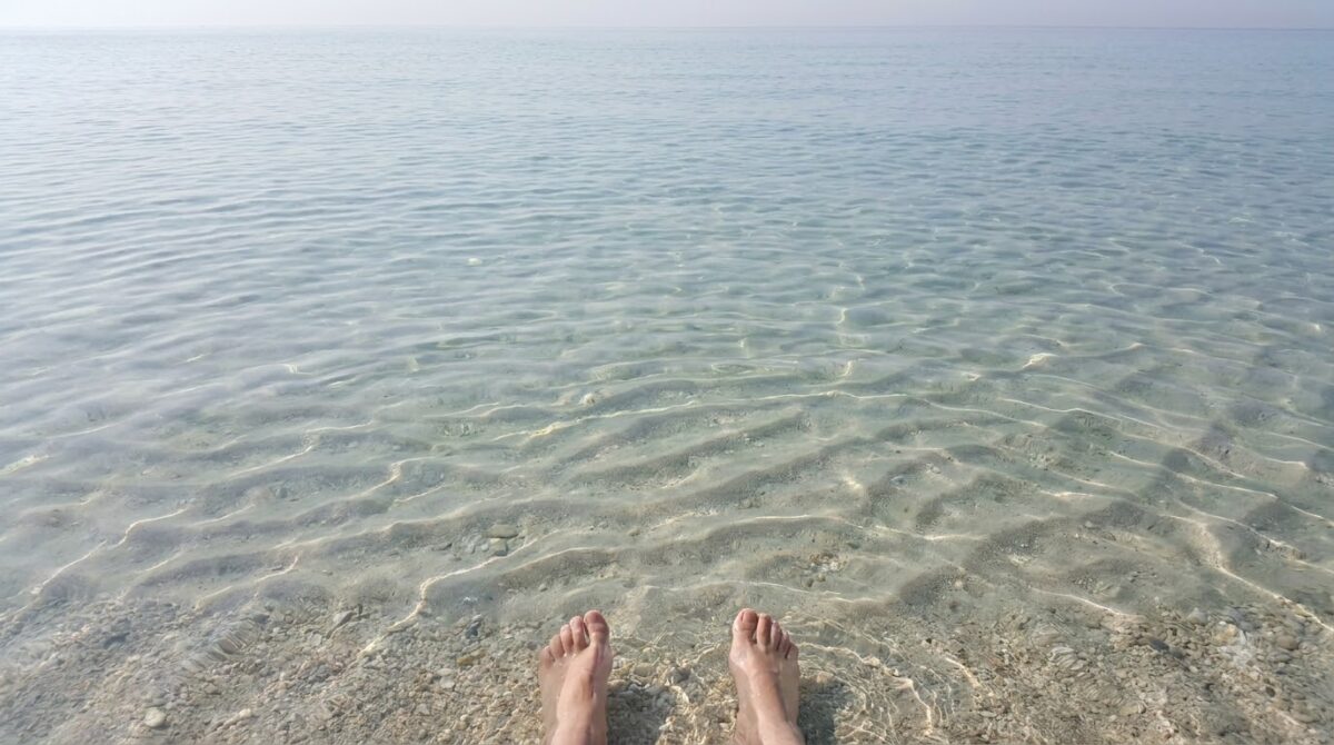 Very clear shallow Caribbean sea over pale sand with ripple patterns