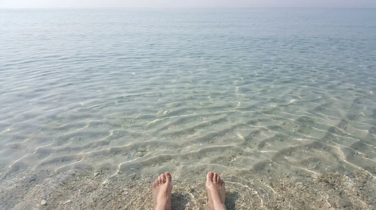 Very clear shallow Caribbean sea over pale sand with ripple patterns