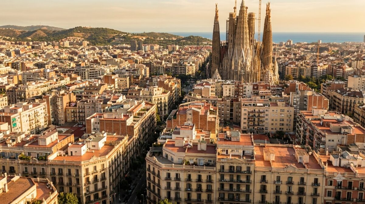 The rooftops of Barcelona seen from above with the Sagrada Familia rising over them