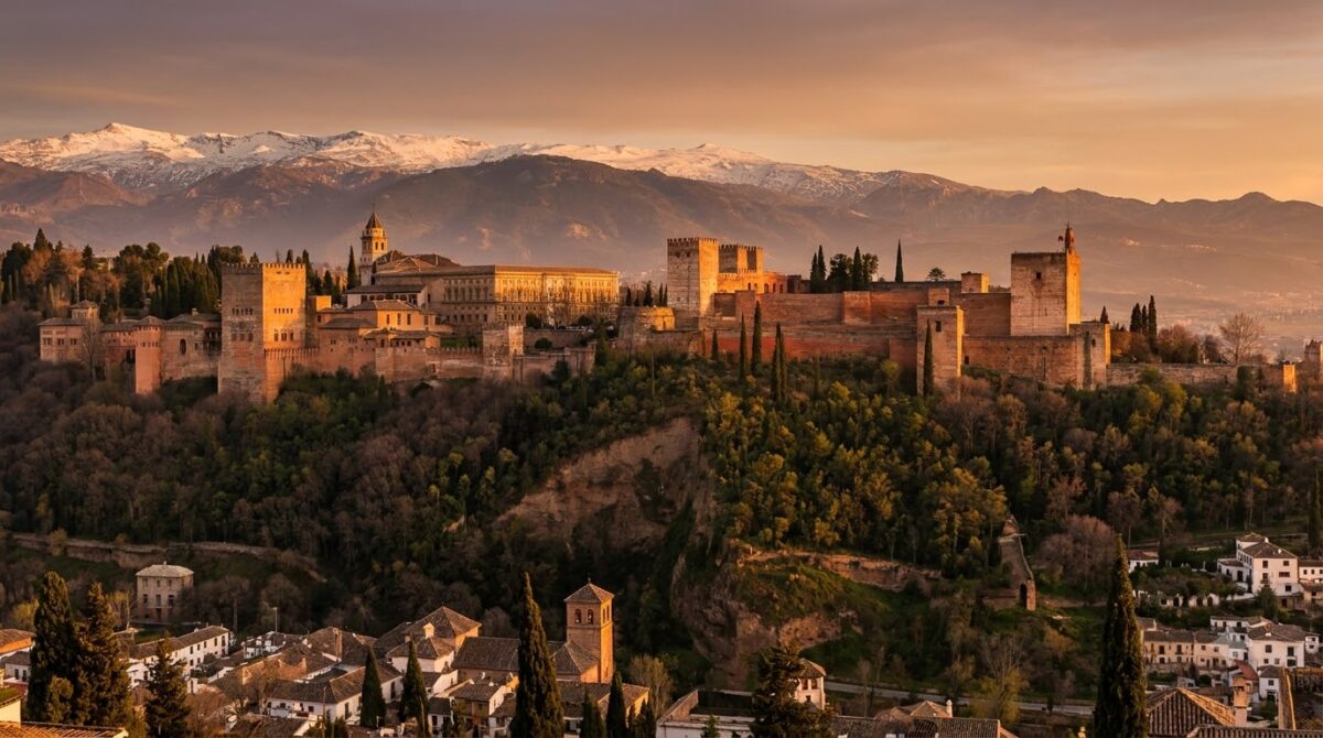 The Alhambra palace complex on its hill with the Sierra Nevada behind