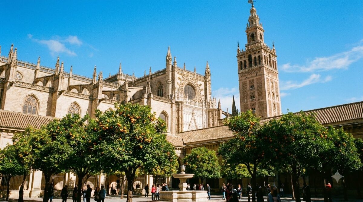 Seville Cathedral with the Giralda bell tower and orange trees below