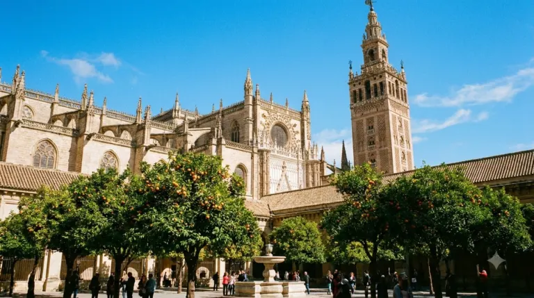 Seville Cathedral with the Giralda bell tower and orange trees below