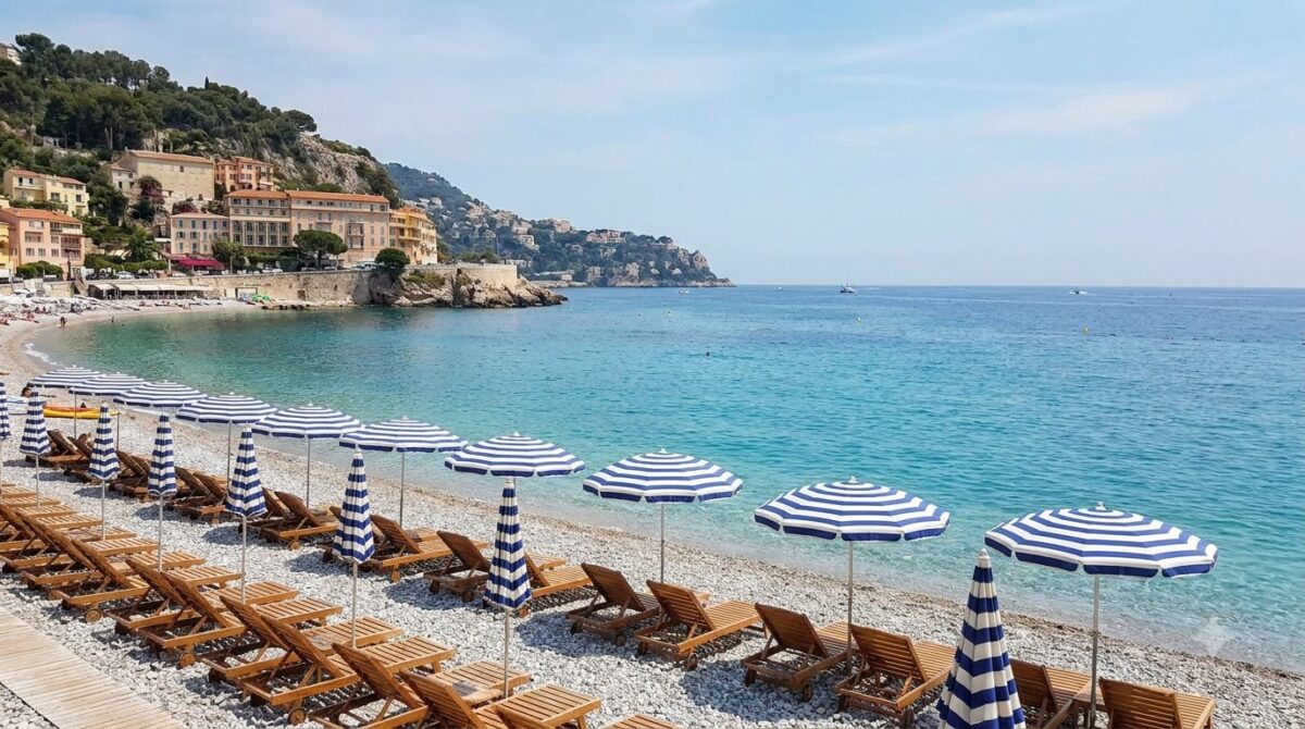 The pebble beach and blue water of the Baie des Anges at Nice