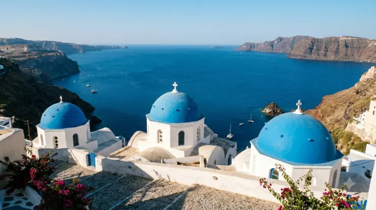 Blue church domes and white walls above the caldera in Santorini