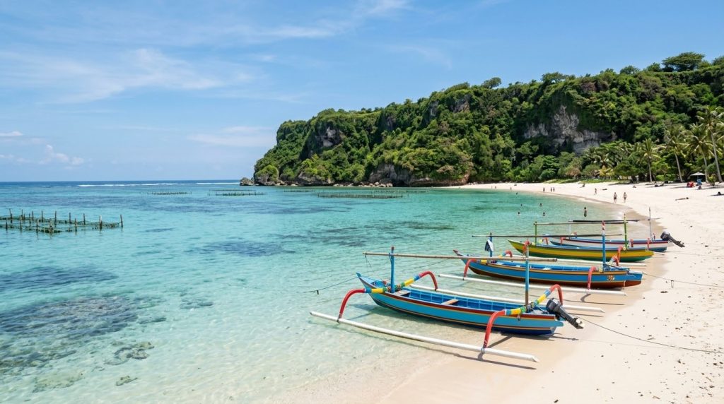 Calm turquoise water and jukung boats on Geger Beach in Nusa Dua, Bali