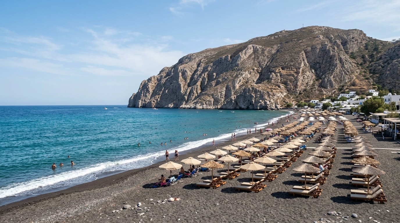 Kamari black-sand beach in Santorini in June before peak crowds