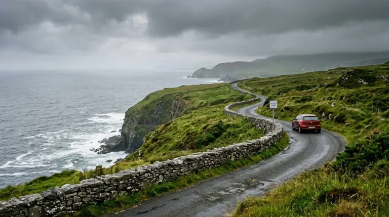 A narrow coastal road winding along green cliffs above the Atlantic, west of Ireland