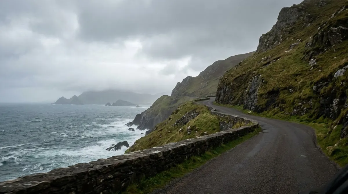 A narrow coastal road along steep green cliffs above the Atlantic, Slea Head, Dingle Peninsula, Ireland