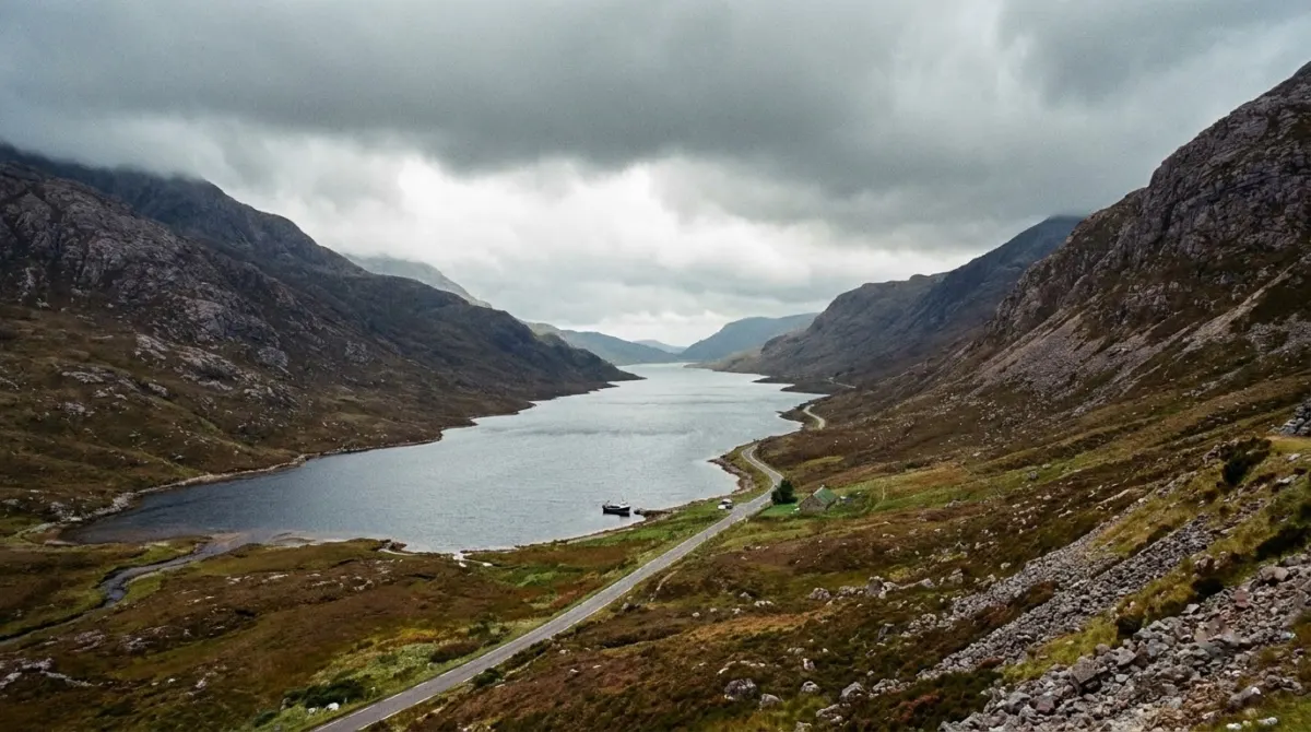 A long narrow loch between steep hills under heavy cloud, Scottish Highlands